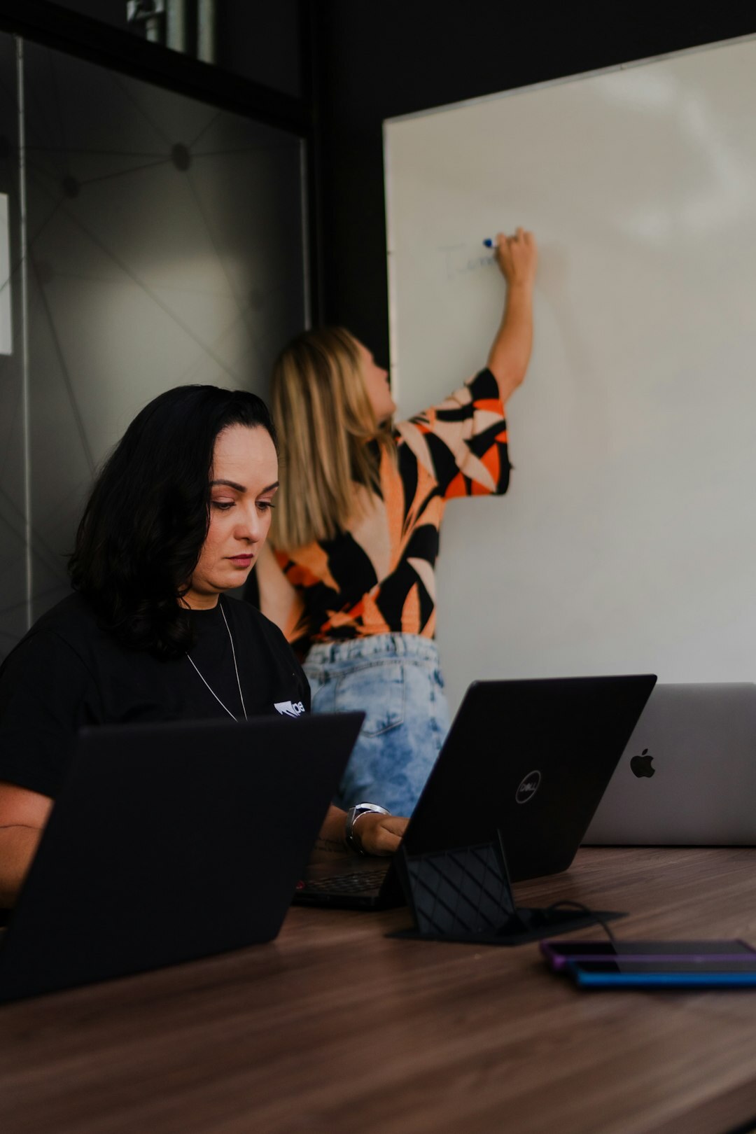 Small team collaborating around a laptop in a modern office