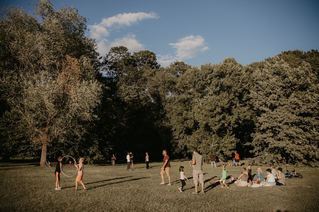 Group of colleagues doing an outdoor team building challenge in a park