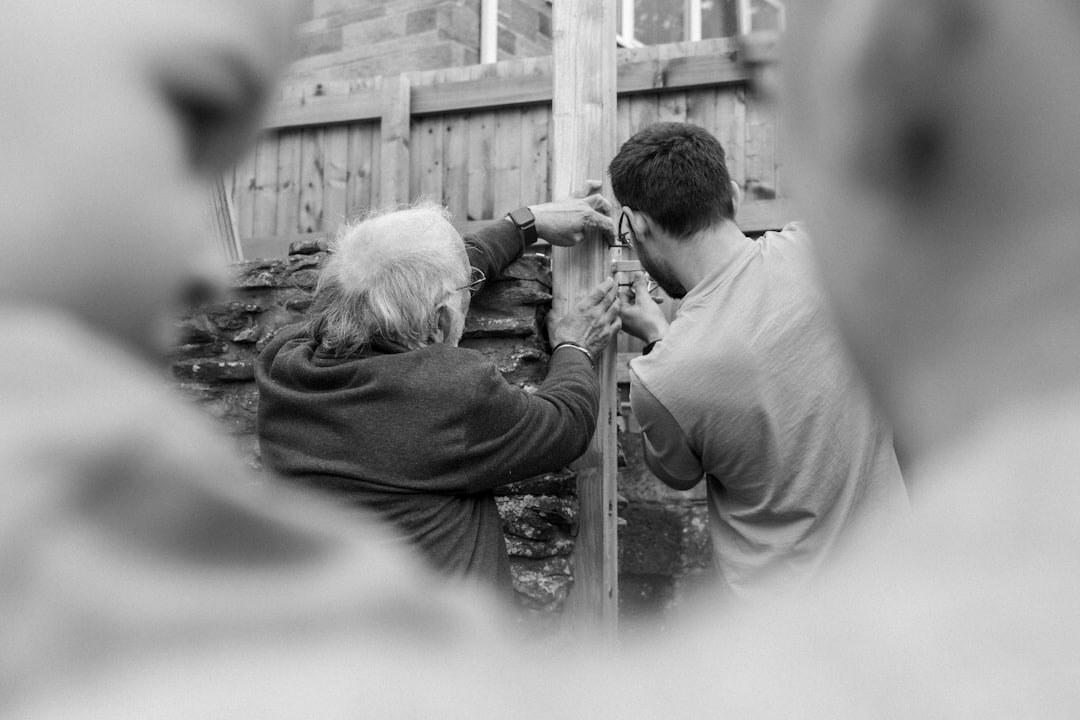 Close-up of hands building a structure together during a workshop