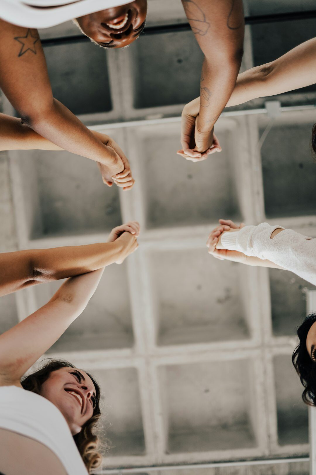 Team celebrating together with raised hands after a team building event